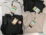 three pairs of men ' s pants with tags on them sitting on a table
