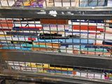 books are stacked on a metal rack in a book store