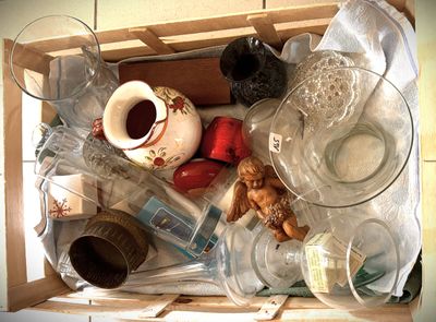 a box full of empty glassware and other items
