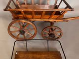 an old fashioned wooden wagon with wheels and a wooden shelf