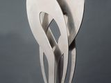 sculpture of a couple of spoons sitting on top of a white pedestal