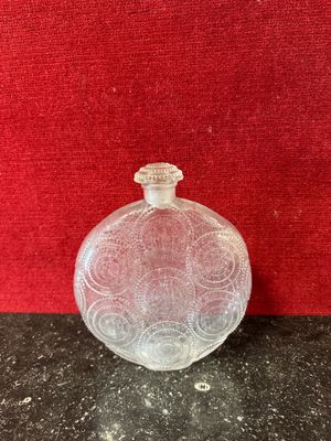 a clear glass bottle sitting on top of a table