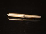 a pen that is laying on a black surface