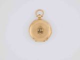 an old gold pocket watch with a picture of a man on it