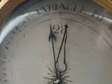 a gold clock with a bird on top of it