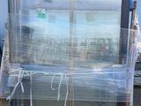 a pallet with a large window that is wrapped in plastic