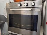 an oven that is sitting on a stand in the kitchen