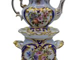 a blue and white tea pot and two cups on top of each other