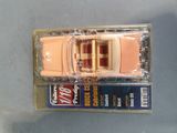 a toy car that is in a package on a table