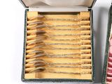 many spoons in a box on a white surface