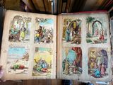 a person holding an open book with pictures of people on it