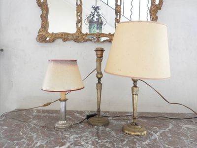 two lamps sitting on a table with a mirror in the background