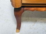a wooden dresser with a drawer underneath it