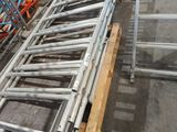 a long metal conveyor belt in the middle of a warehouse