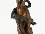statue en bronze d'une femme tenant un oiseau sur un piédestal