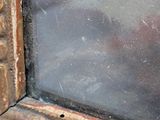 a close up of a window with a glass in it