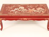 a red coffee table with a floral design on the top