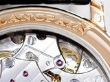 a close up of a watch with a black leather strap