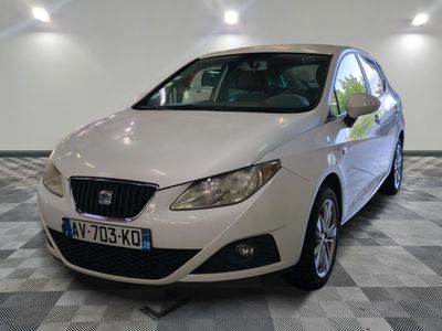 une voiture blanche garée sur un sol à carreaux