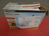 a box with a sewing machine in it sitting on a table