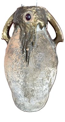a vase with a face on it sitting on a table