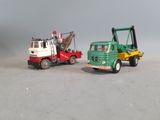 two toy trucks that are sitting next to each other