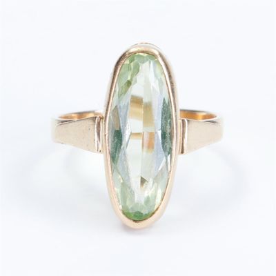a picture of a ring with a green stone in it