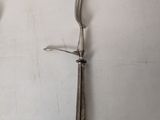 two forks and a knife on a white table