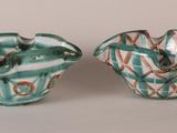pair of green and white vases sitting on top of a table