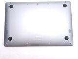 the back of a silver laptop computer sitting on top of a white surface