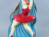 figurine of a ballerina in a red dress on a blue background
