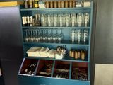 a blue cabinet with a lot of glasses and bottles on it