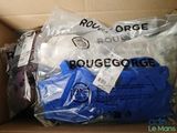 a cardboard box filled with clothes and a bag of luggage