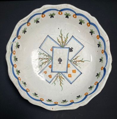 a white plate with blue and orange designs on it