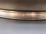 a close up of a silver plate on a table