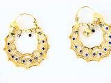 pair of blue and gold hoop earrings on a white background
