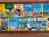 many children ' s books on a shelf on the floor