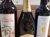 three bottles of wine sitting on a table next to each other
