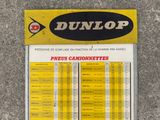 a sign that says dunlop on the side of the road
