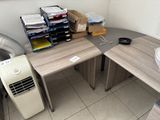 a desk with a fan and a computer on it