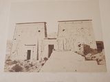 an old picture of a building with a horse in front of it