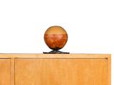 an apple sitting on top of a wooden cabinet
