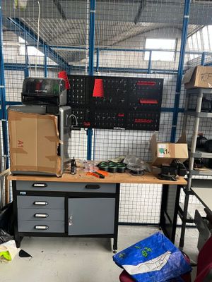 an image of a workbench in a warehouse with a lot of tools