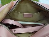 a person holding a pink purse with a cell phone in it