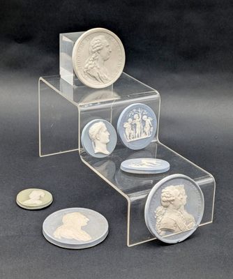 a stack of coins and a coin with a picture of a man on it