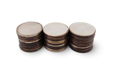 a close up of a stack of coins on a white surface