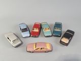 several toy cars are arranged in a circle on a white surface