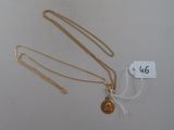 two gold necklaces with a gold coin on a white background