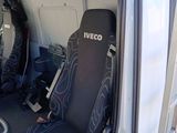 a seat in the back of a truck with a seat cover on