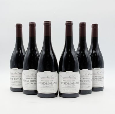 six bouteilles de vin sont alignées sur une surface blanche